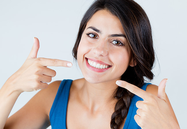 Girl smiling after having dental veneers