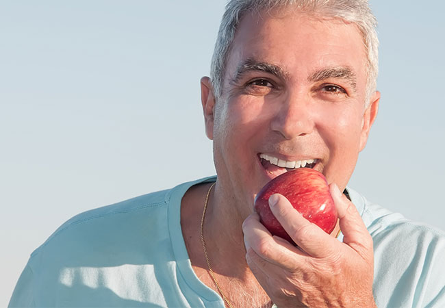 Dental patient biting apple