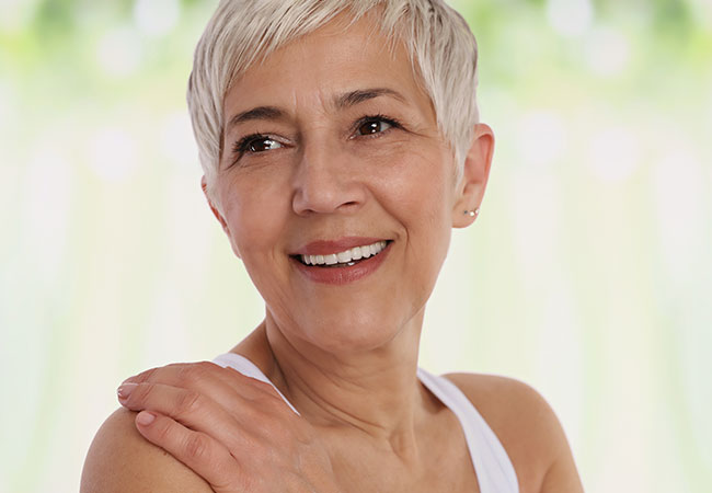 Women smiling with after dental implants